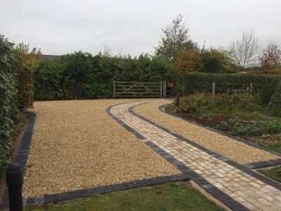 Gold gravel driveway with brick paved pathway