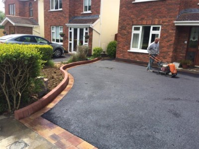 Tarmac driveway with brick on edge on a lazy S boundary
