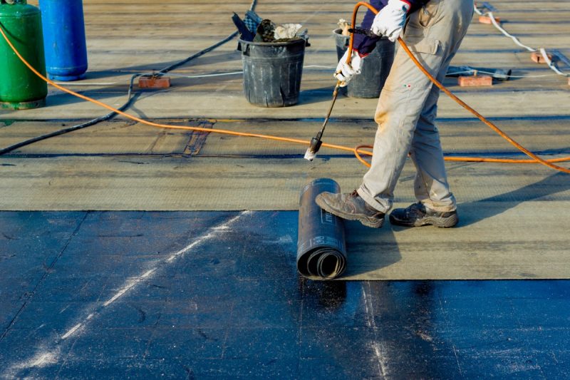 Worker,Preparing,Part,Of,Bitumen,Roofing,Felt,Roll,For,Melting Worker,Preparing,Part,Of,Bitumen,Roofing,Felt,Roll,For,Melting