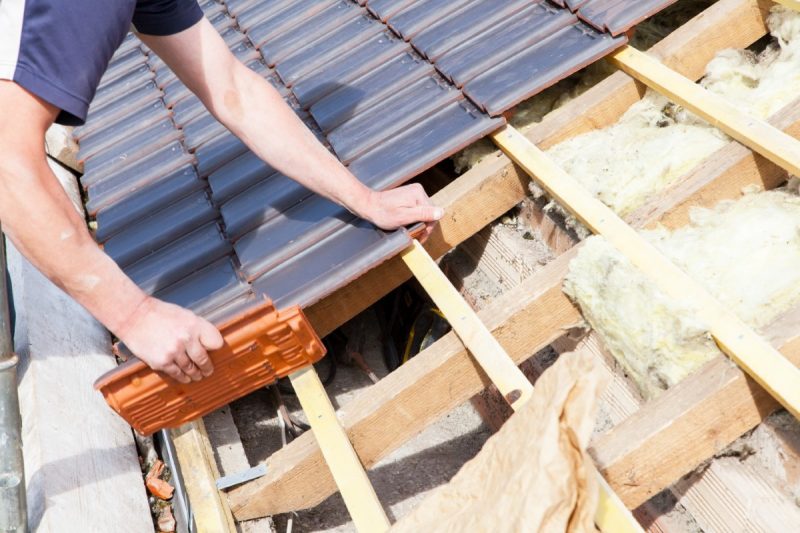 A,Roofer,Laying,Tile,On,The,Roof A,Roofer,Laying,Tile,On,The,Roof
